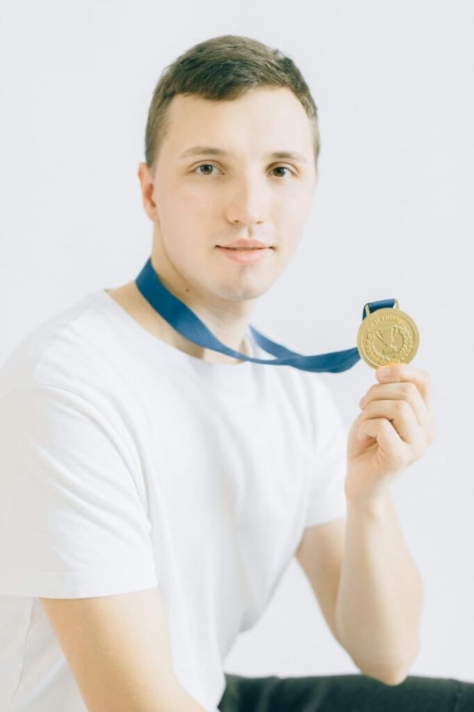 A person showing his gold medal means the success stories for Inspirational blog